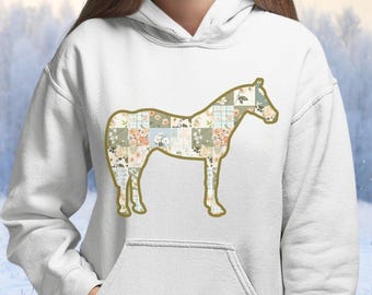 May include: White hoodie featuring a horse silhouette filled with a patchwork design of floral and plaid patterns in pastel colors. The horse outline is outlined in a gold color.