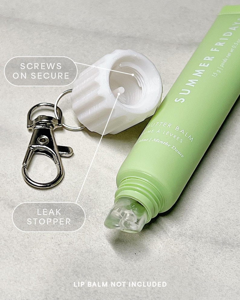 May include: A white plastic bottle stopper with a screw-on lid and a silver keychain. The bottle stopper has a small hole in the center. The keychain has a leak stopper. The text "SCREWS ON SECURE" and "LEAK STOPPER" are written on the image.