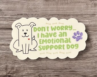 May include: A white sticker with a cartoon dog and the text "Don't worry... I have an emotional support dog" with a paw print in the corner.