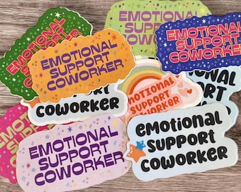 May include: A collection of colorful stickers with the text "Emotional Support Coworker" in various fonts and designs. The stickers are decorated with stars, hearts, and rainbows.