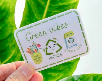 May include: Green vibes sticker with a green recycle symbol with a face, a yellow bag with the text "Bring your own bag", and a blue recycling bin with the text "Earth Day Every Day".