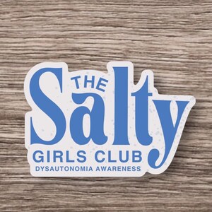 May include: A blue and white sticker with the text "The Salty Girls Club Dysautonomia Awareness".