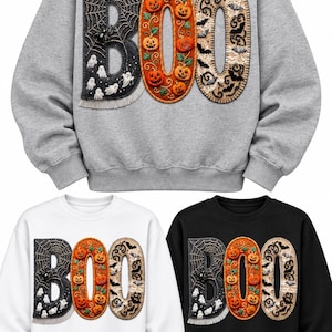 May include: Three crewneck sweatshirts in gray, white, and black, each featuring the word BOO in large applique letters. The B has a spiderweb and ghost design, the O is filled with orange pumpkins, and the second O features bats and lace.