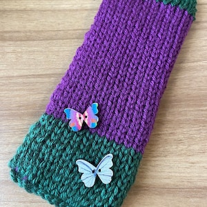 Soft two-toned handknit fingerless gloves with a butterfly accent...