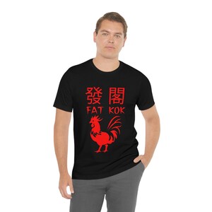May include: Black t-shirt with a red rooster graphic and the text "Fat Kok" in Chinese and English.