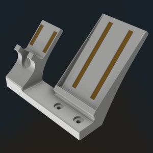 May include: A light gray, angled stand with two parallel, rectangular, brown accents. The stand has a curved section with a circular indentation and two holes at the base. The design is modern and minimalist.