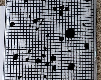 May include: Black and white image of a grid with black shapes scattered throughout. The grid is made up of small squares.