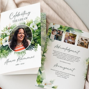 May include: A memorial card featuring the text "Celebrating the Life of Alamea Kahananui 1980-2030" and a portrait of a woman. The card is adorned with tropical flowers and greenery. The inside includes photos and text.