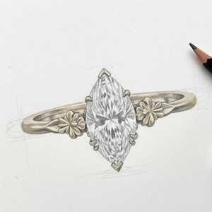 Puede incluir: Boceto a l&aacute;piz de un anillo de compromiso con un diamante talla marquesa. El anillo tiene una banda dorada con detalles florales a cada lado del diamante. Un l&aacute;piz y una goma de borrar est&aacute;n en el fondo.