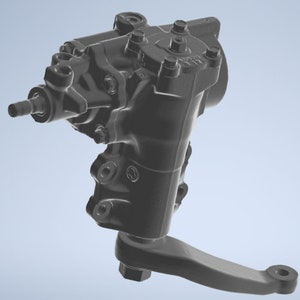 May include: A black metal steering gear box with a single arm extending out to the right. The gear box has multiple bolts and a circular opening on the side.