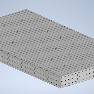 May include: A gray metal work surface with a grid pattern of holes. The surface is rectangular and has a slightly angled edge.
