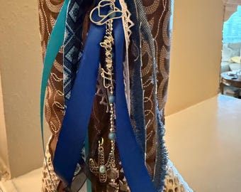 Boot Bling! Southwest/Western ribbon. Shades of blue, black, white and denim blue with 4 pewter charms. 9” long. Colors go great together!