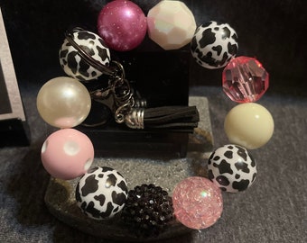 Porte-clés bracelet grosse perle Bubblegum "Milkshake aux fraises" imprimé vache, rose, blanc, noir