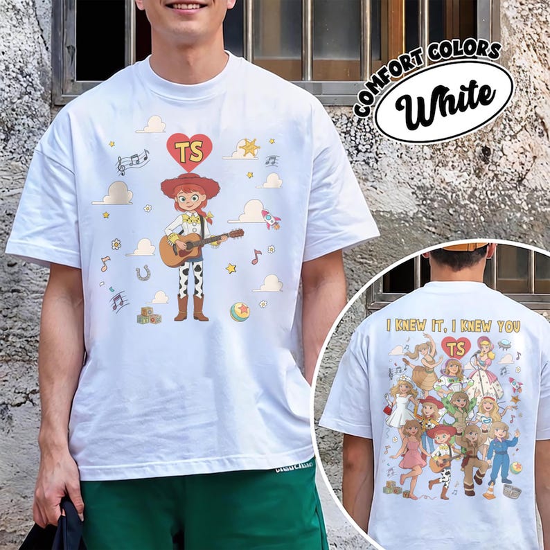 May include: A white short-sleeve t-shirt featuring a graphic of a cowgirl character playing a guitar on the front. The back of the shirt displays a collage of various characters with the text "I KNEW IT, I KNEW YOU" and "TS" inside a red heart.