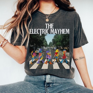 May include: Dark gray t-shirt featuring "THE ELECTRIC MAYHEM" in white text above a colorful image of the band crossing a street. The image is a parody of the Beatles' Abbey Road album cover.