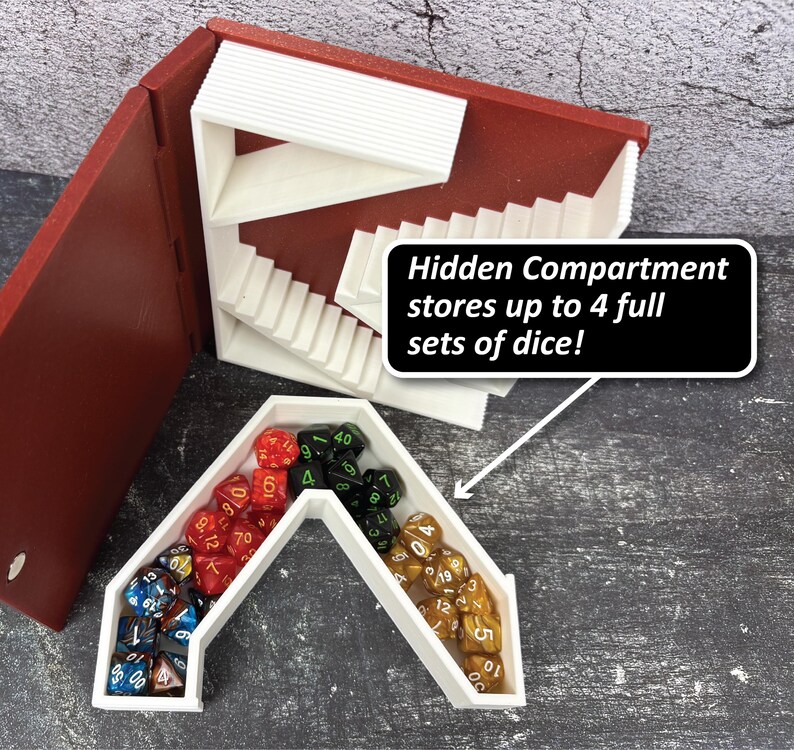 May include: A red and white dice storage box with a hidden compartment. The box is open, revealing a white interior with a staircase design. The box contains multiple sets of dice in various colors. Text on the image reads: "Hidden Compartment stores up to 4 full sets of dice!"
