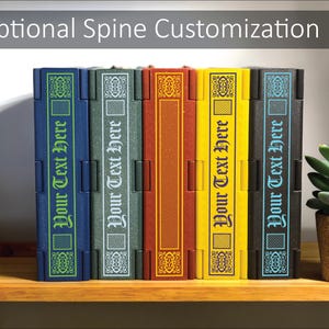 May include: A row of colorful book-shaped boxes with the text "Your Text Here" on the spines. The boxes are in shades of blue, green, red, yellow, and black. The text "Optional Spine Customization" is at the top.