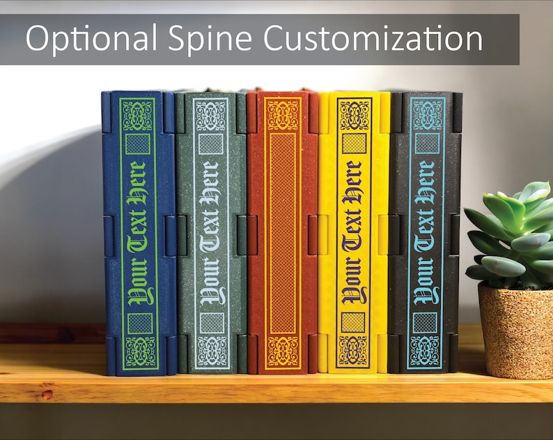 May include: A row of colorful book-shaped boxes with the text "Your Text Here" on the spines. The boxes are in shades of blue, green, red, yellow, and black. The text "Optional Spine Customization" is at the top.