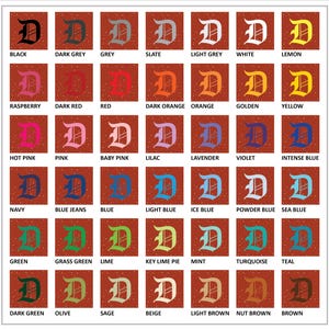 May include: A grid of color swatches, each featuring a capital letter "D" in a different color. Colors include black, grey, red, orange, yellow, pink, blue, green, and brown, with various shades and hues. Each swatch has a color name.