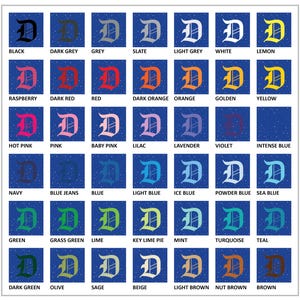 May include: A grid of color swatches, each featuring a stylized letter "D" in various colors. Colors include black, grey, red, orange, yellow, pink, blue, green, and brown, with corresponding color names below each swatch.