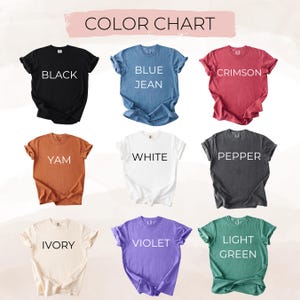 May include: A color chart displaying nine t-shirts in various colors. The colors include black, blue jean, crimson, yam, white, pepper, ivory, violet, and light green. Each shirt has the color name printed on it.