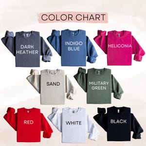 May include: A color chart displays eight crewneck sweatshirts in various colors. The colors include dark heather, indigo blue, heliconia, sand, military green, red, white, and black. The text "COLOR CHART" is at the top.