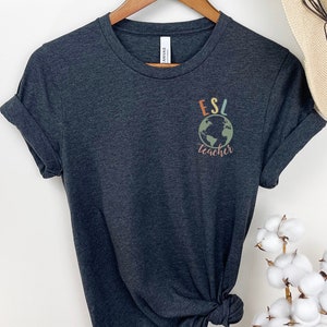 May include: Dark gray t-shirt with a colorful graphic of a globe and the text "ESL teacher".