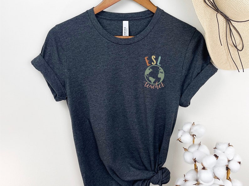 May include: Dark gray t-shirt with a colorful graphic of a globe and the text "ESL teacher".
