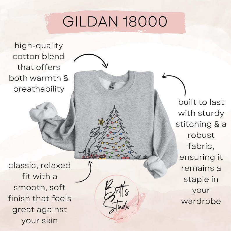 May include: A light grey Gildan 18000 sweatshirt with a Christmas tree design. The sweatshirt has a classic, relaxed fit and is made of a high-quality cotton blend. The design includes a dog decorating a Christmas tree with colourful lights.