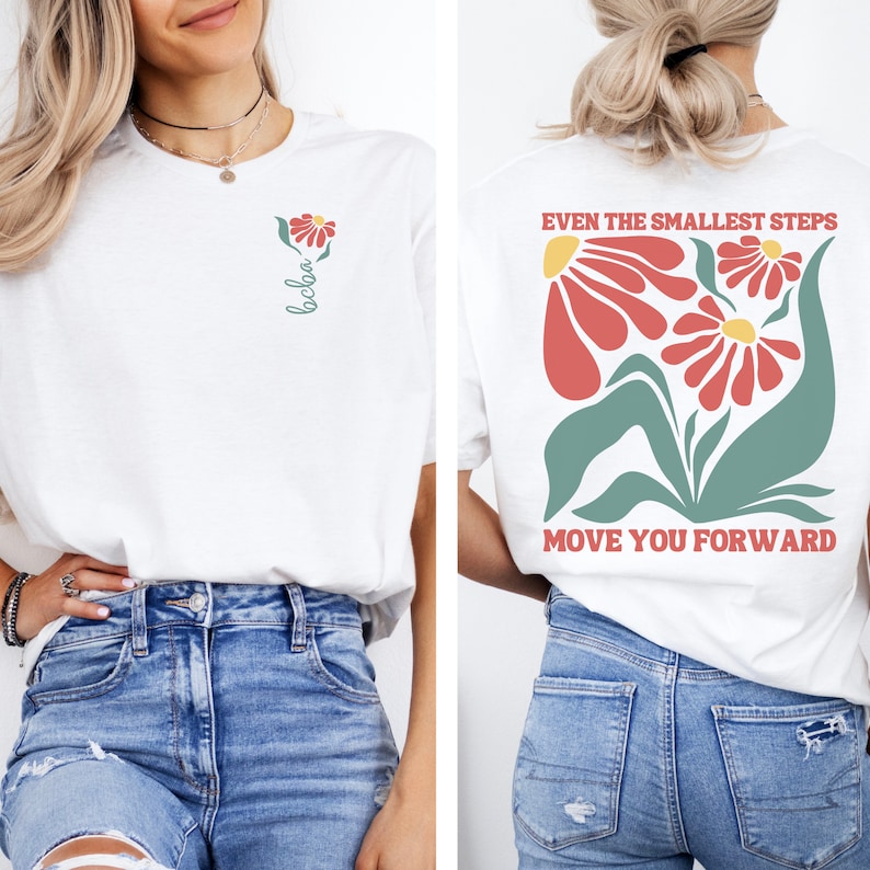 May include: White t-shirt with a floral design and the text "Even the smallest steps move you forward" on the back. The front of the shirt has a small flower design and the word "bloom" written vertically.
