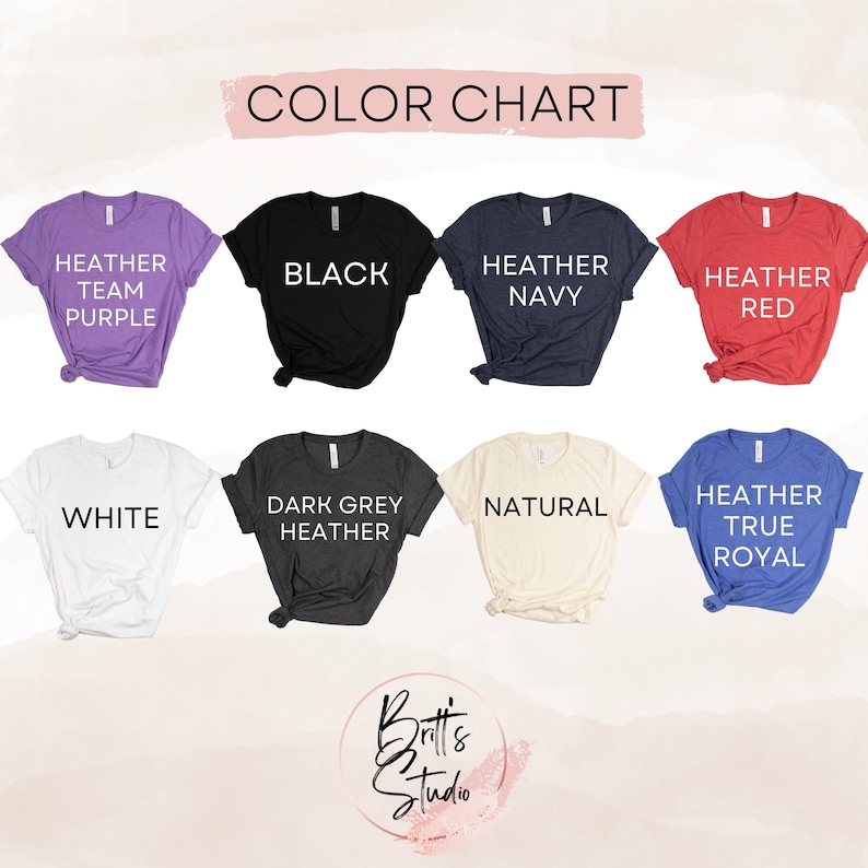 May include: Color chart featuring eight t-shirts in various colors: Heather Team Purple, Black, Heather Navy, Heather Red, White, Dark Grey Heather, Natural, and Heather True Royal. The text "COLOR CHART" is at the top.