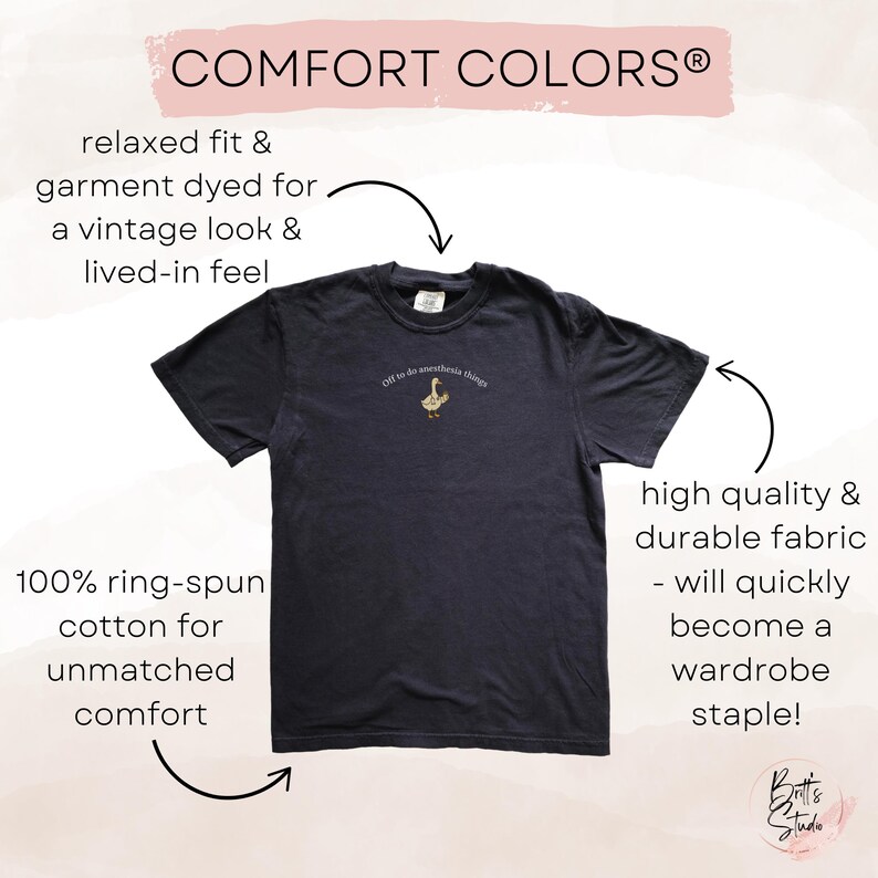May include: A dark navy blue t-shirt with the text "Off to do anesthesia things" above a small embroidered goose. The shirt is made of 100% ring-spun cotton and is garment dyed for a vintage look.