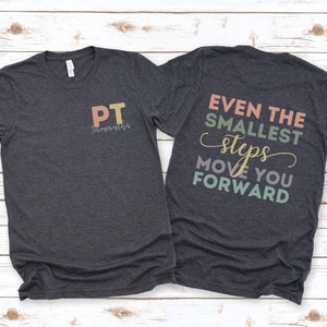 May include: A dark heather grey t-shirt with the text "PT Samantha" on the front and the text "Even the smallest steps move you forward" on the back. The text is in various pastel colors.