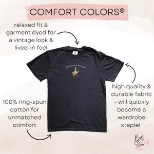 May include: Dark navy blue t-shirt with the text "Off to be the fun aunt" and a cartoon goose graphic. The shirt is made of 100% ring-spun cotton and has a relaxed fit. The shirt is garment dyed for a vintage look.