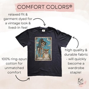 May include: A dark grey t-shirt with a vintage look and feel. The shirt features a graphic of a skeleton holding a bulldog with the text "The Bulldog Mom". The shirt is made of 100% ring-spun cotton for unmatched comfort.
