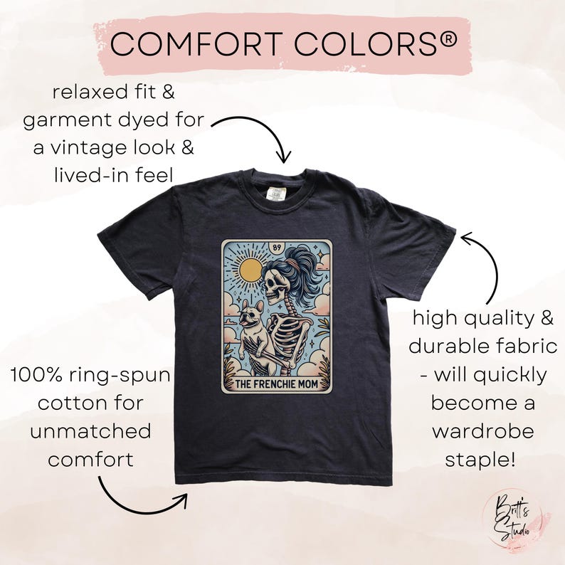 May include: A dark gray t-shirt with a vintage-style illustration of a skeleton holding a small dog. The illustration is on a tarot card with the text "The Frenchie Mom" and the number "89".