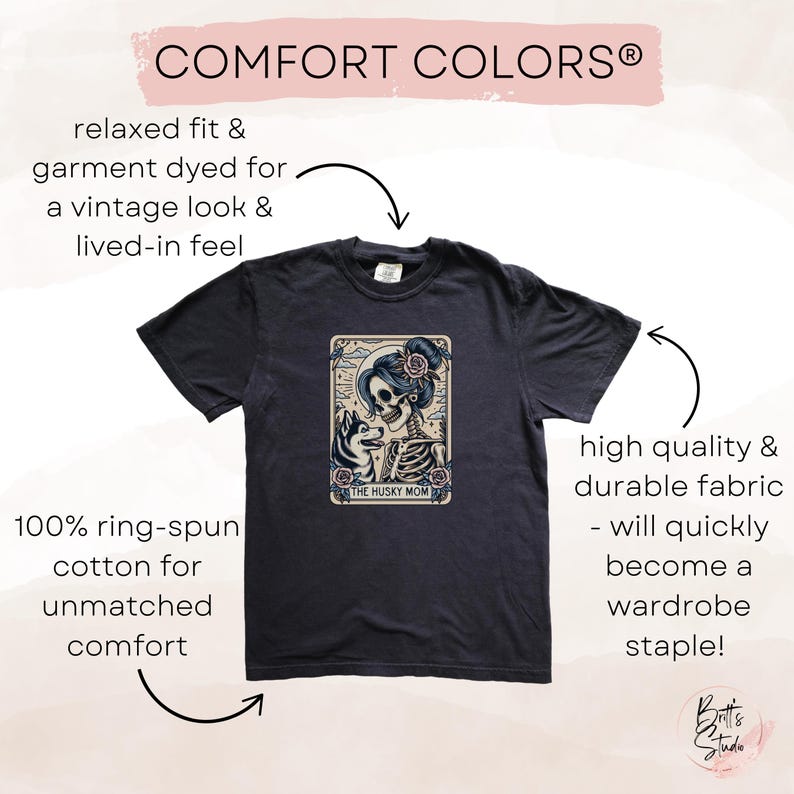 May include: Dark navy blue t-shirt with a graphic featuring a skeleton woman with a husky dog, the text "THE HUSKY MOM", and the words "COMFORT COLORS". The shirt is made of 100% ring-spun cotton.