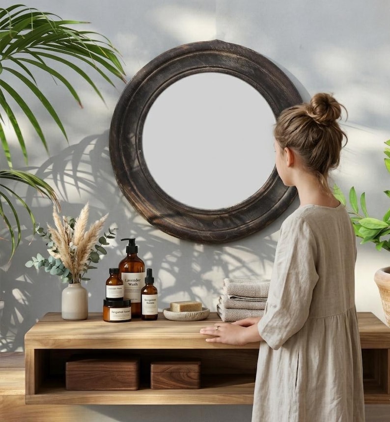 Handcrafted round mirror with a reclaimed teak wood frame and smoky black finish, featuring rounded edges and natural wood character. Rustic wall mirror for bedroom, bathroom, living room or entryway. Reclaimed teak mirror, round wooden mirror, black wood mirror, handmade wall decor, rustic home decor, sustainable wood furniture, artisan-crafted mirror.