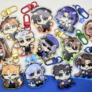 May include: A collection of twelve acrylic keychains featuring chibi-style anime characters in suits, each attached to a colourful metal lobster clasp. The characters have varied hair colours and expressions, with some holding small items like a candle or rope.