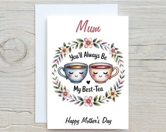 May include: A greeting card for Mother's Day with a white envelope. The card features a floral wreath surrounding two cartoon teacups with smiling faces. The text reads "Mum, You'll Always Be My Best-Tea, Happy Mother's Day."
