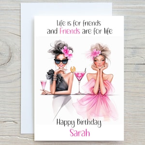 May include: A birthday card featuring a pink and black illustration of two women with cocktails. The text reads "Life is for friends and friends are for life. Happy Birthday Sarah."