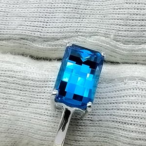 Peut inclure: Une bague en argent avec une pierre bleue carrée.
