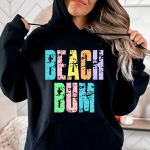 May include: Black hoodie with a colorful distressed graphic that says "Beach Bum".