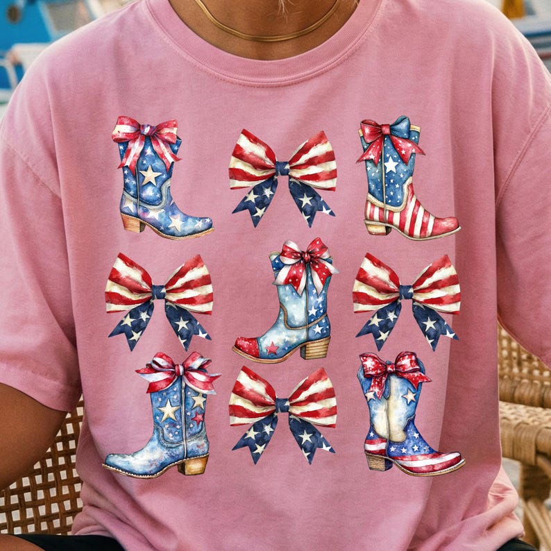 May include: Pink t-shirt featuring a repeating pattern of watercolor cowboy boots and bows. The boots are blue with white stars and red accents, while the bows display a red, white, and blue American flag design.