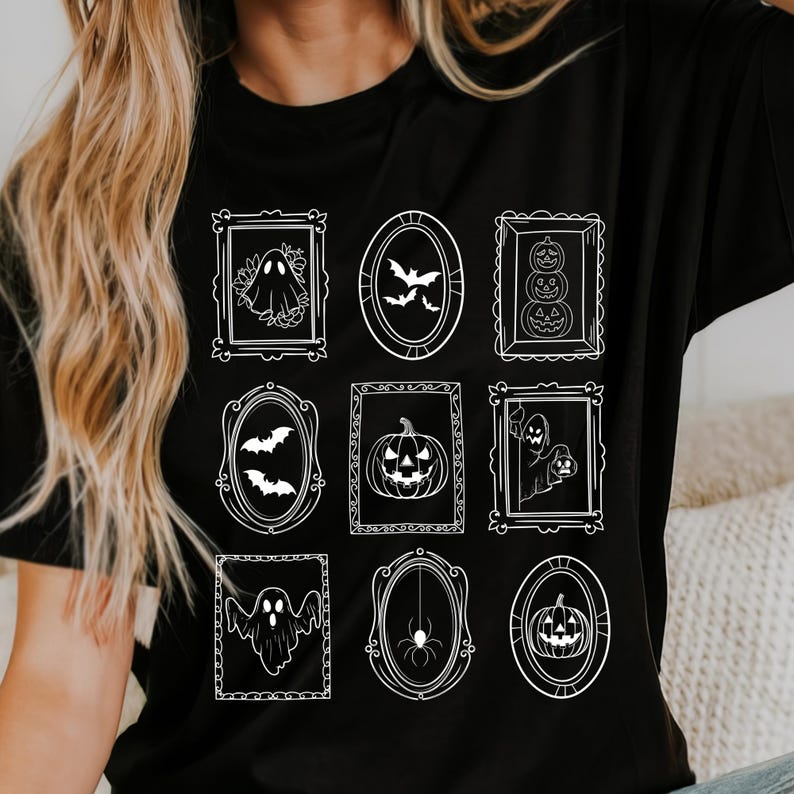 May include: Black t-shirt featuring nine white framed Halloween-themed illustrations. The designs include ghosts, bats, pumpkins, and a spider. The shirt's design is a grid of framed images, perfect for the spooky season.