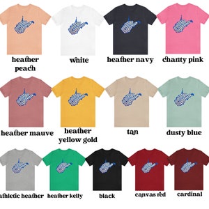 May include: A collection of t-shirts featuring a blue graphic of the state of West Virginia with the words "Mountain Momma" spelled out in the shape of the state. The shirts are available in a variety of colors, including heather peach, white, heather navy, charity pink, heather mauve, heather yellow gold, tan, dusty blue, athletic heather, heather kelly, black, canvas red, and cardinal.