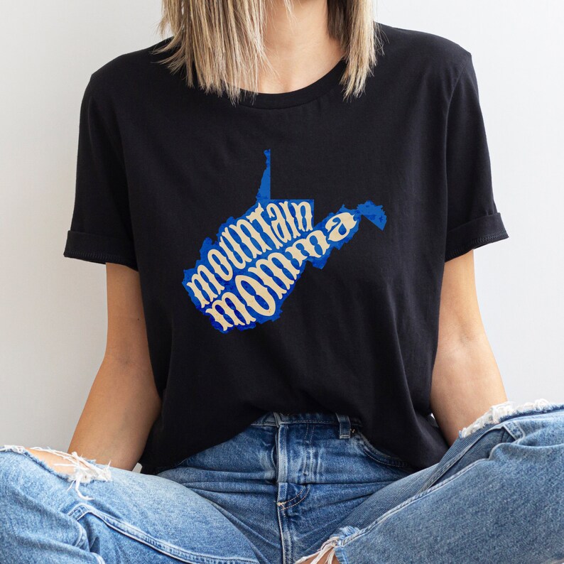 May include: A black t-shirt with a blue and beige graphic of the state of West Virginia with the text "mountain momma" inside the state outline.