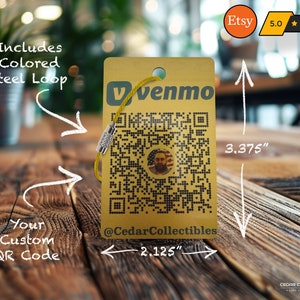 May include: A gold metal tag with a QR code and the text "Venmo" and "@CedarCollectibles". The tag is 3.375 inches tall and 2.125 inches wide. It includes a colored steel loop.