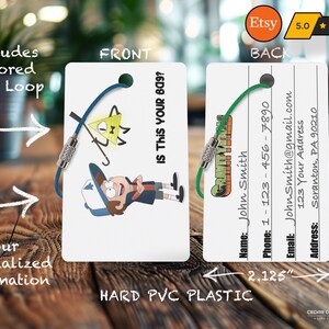 May include: A white plastic luggage tag with a cartoon character from the show Gravity Falls. The front of the tag features a character with a blue hat and a yellow triangle with a single eye. The back of the tag has a space for a name, phone number, email address, and address. The tag is 2.125 inches wide and 3.375 inches tall.