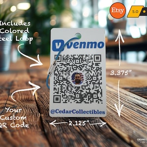 May include: White plastic card with a QR code and the text "venmo" and "@CedarCollectibles". The card is 3.375 inches tall and 2.125 inches wide. It includes a blue lanyard with a colored steel loop.
